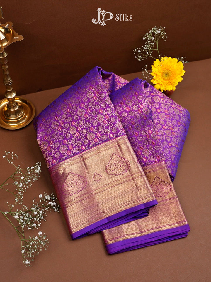 Purple and beige saree with floral patterns on a brown background, featuring JP Silks branding.
